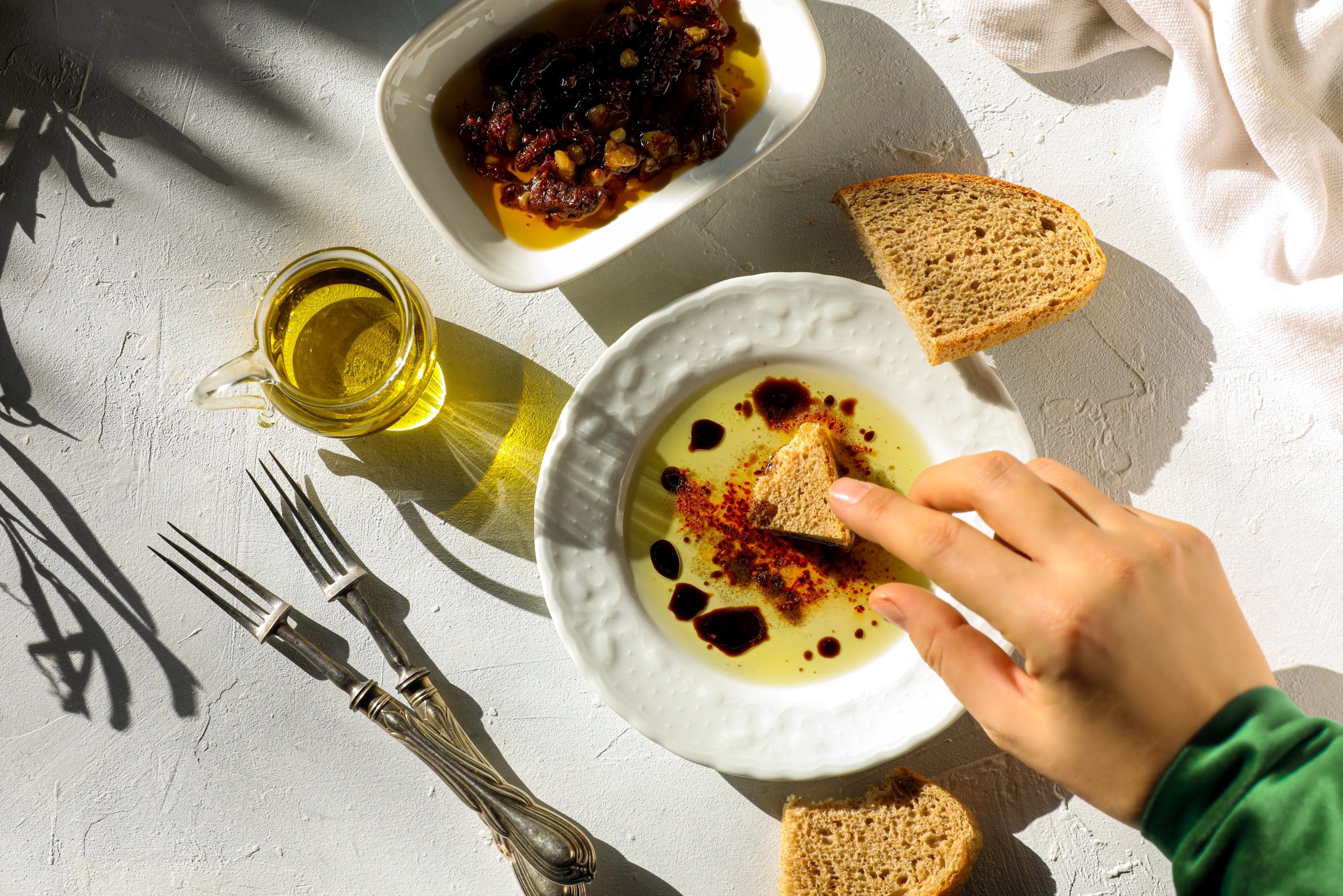 Woman dipping olive oil
